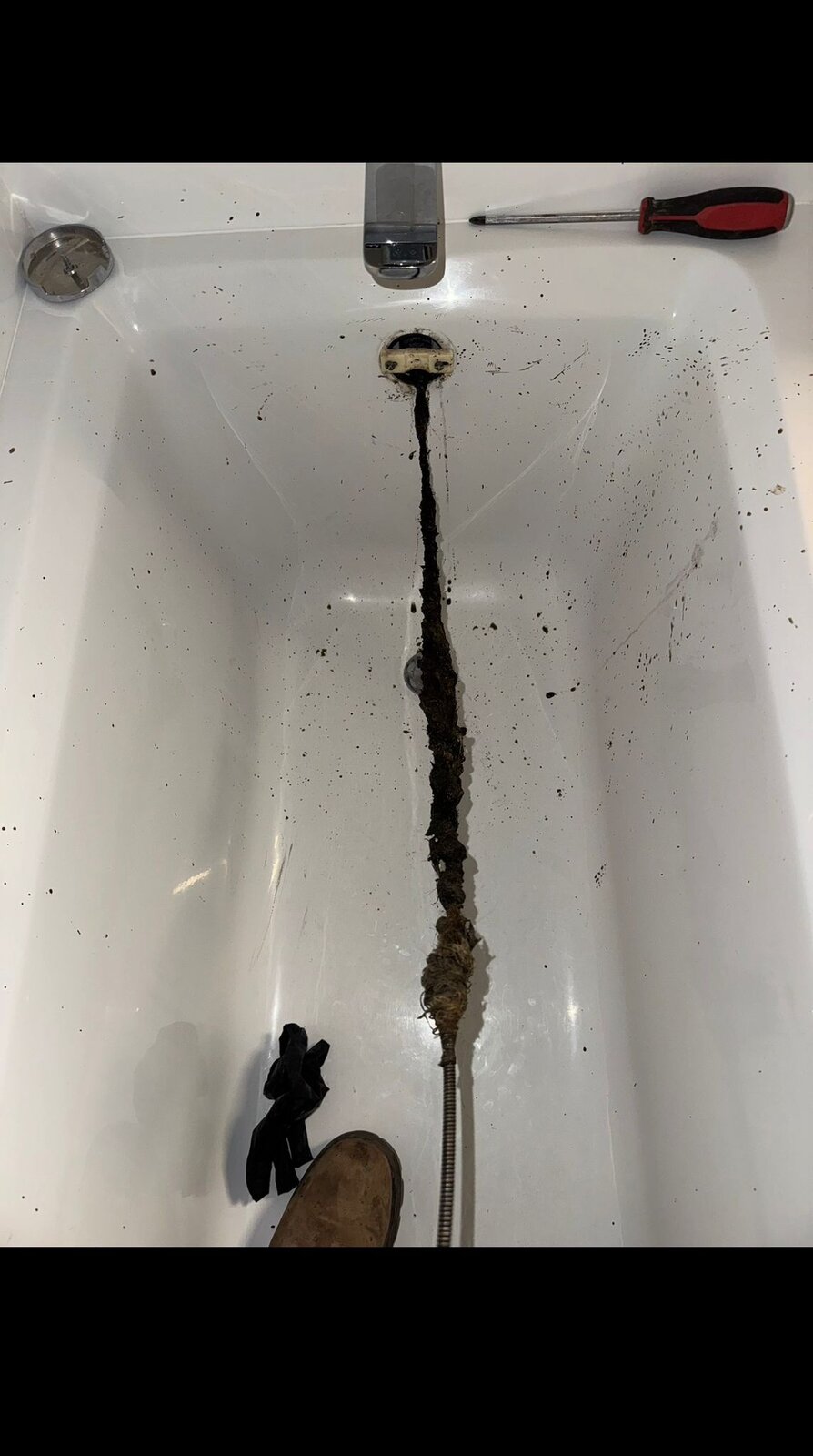 Hair clog removed from a bathtub drain by HYDROPRO in Vancouver